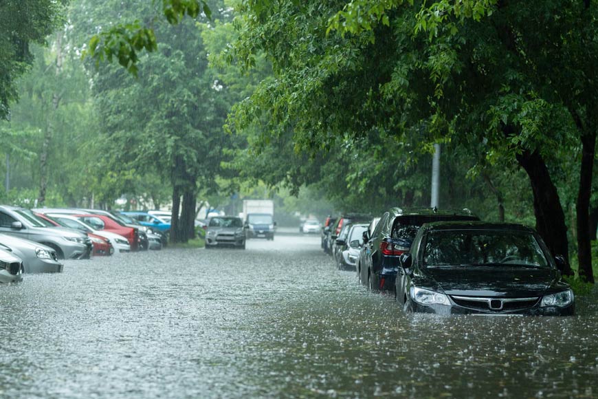 Photo of flooded street with parked cars